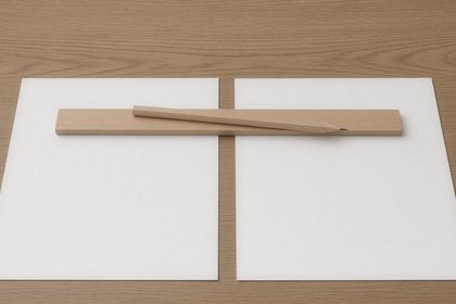 Two blank pages side by side under a wooden ruler and pencil